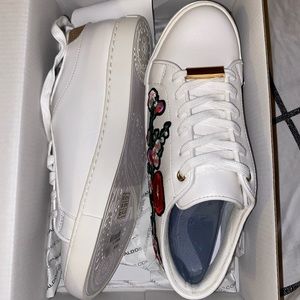 Aldo white with floral patch sneakers.